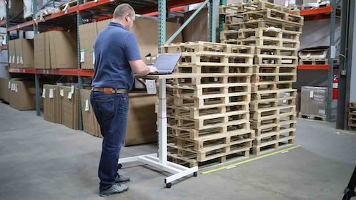 A man submitting a quote on his laptop